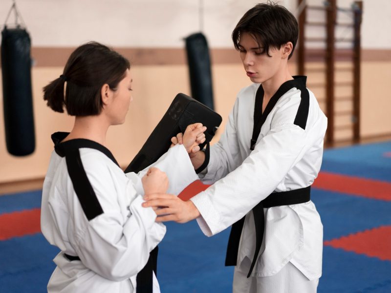 people-practicing-taekwondo-in-a-gymnasium-1.jpg