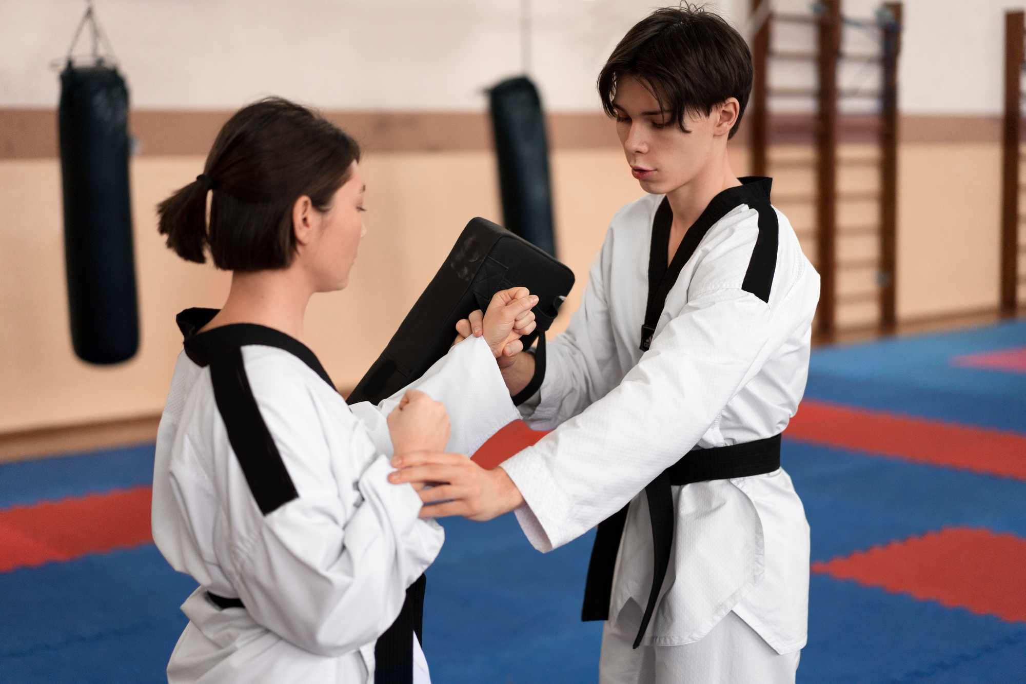 people-practicing-taekwondo-in-a-gymnasium-1.jpg